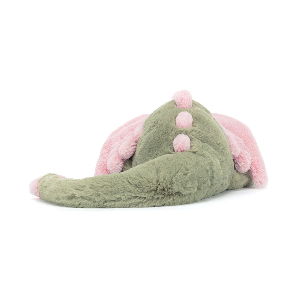 Peluche Jellycat dragon Malachy vert et rose sur lit – Jellycat Malachy dragon green and pink plush on bed – Olie & co