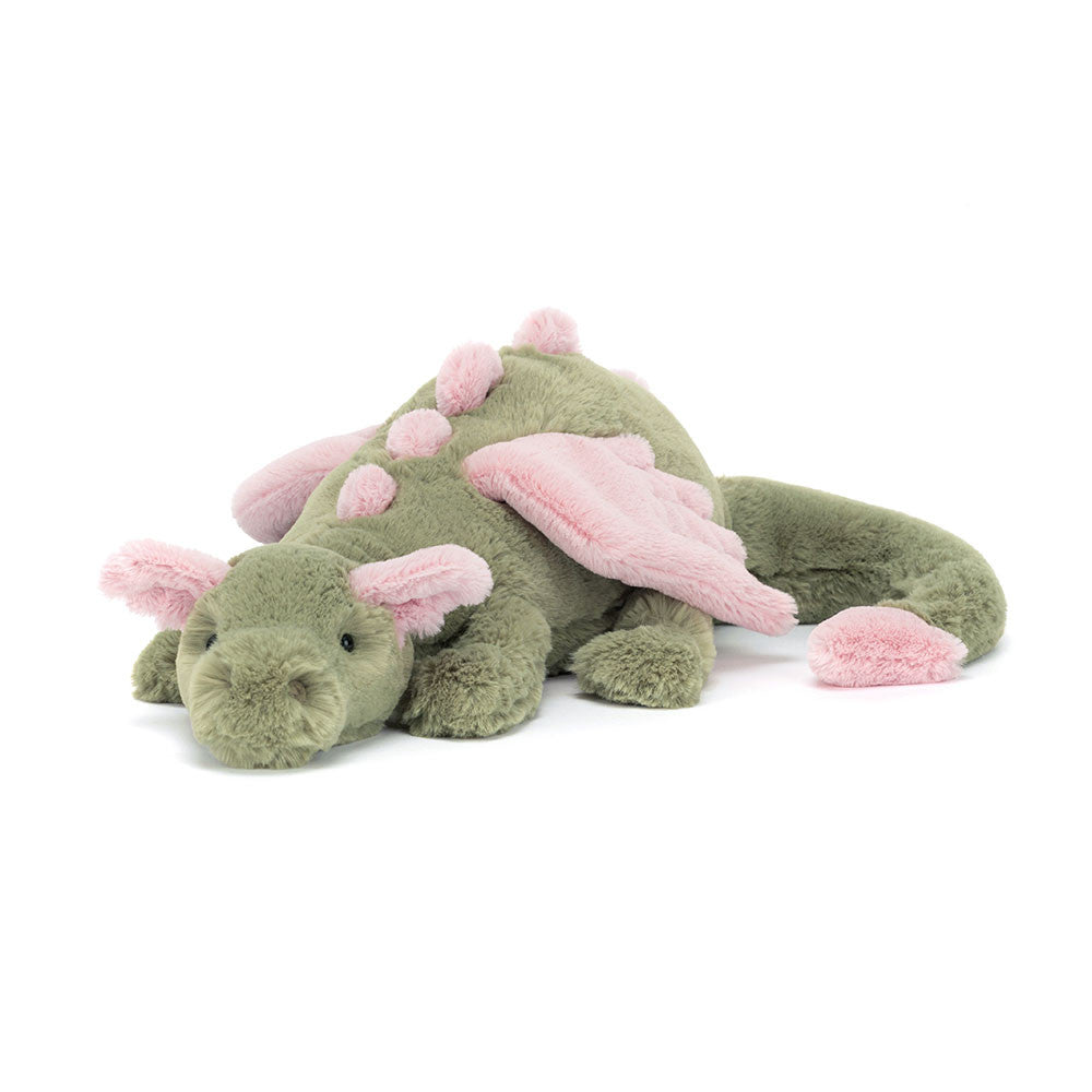 Peluche Jellycat dragon Malachy vert et rose sur lit – Jellycat Malachy dragon green and pink plush on bed – Olie & co