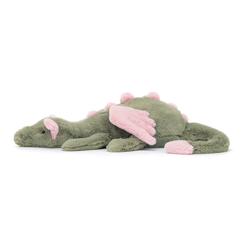 Peluche Jellycat dragon Malachy vert et rose sur lit – Jellycat Malachy dragon green and pink plush on bed – Olie & co