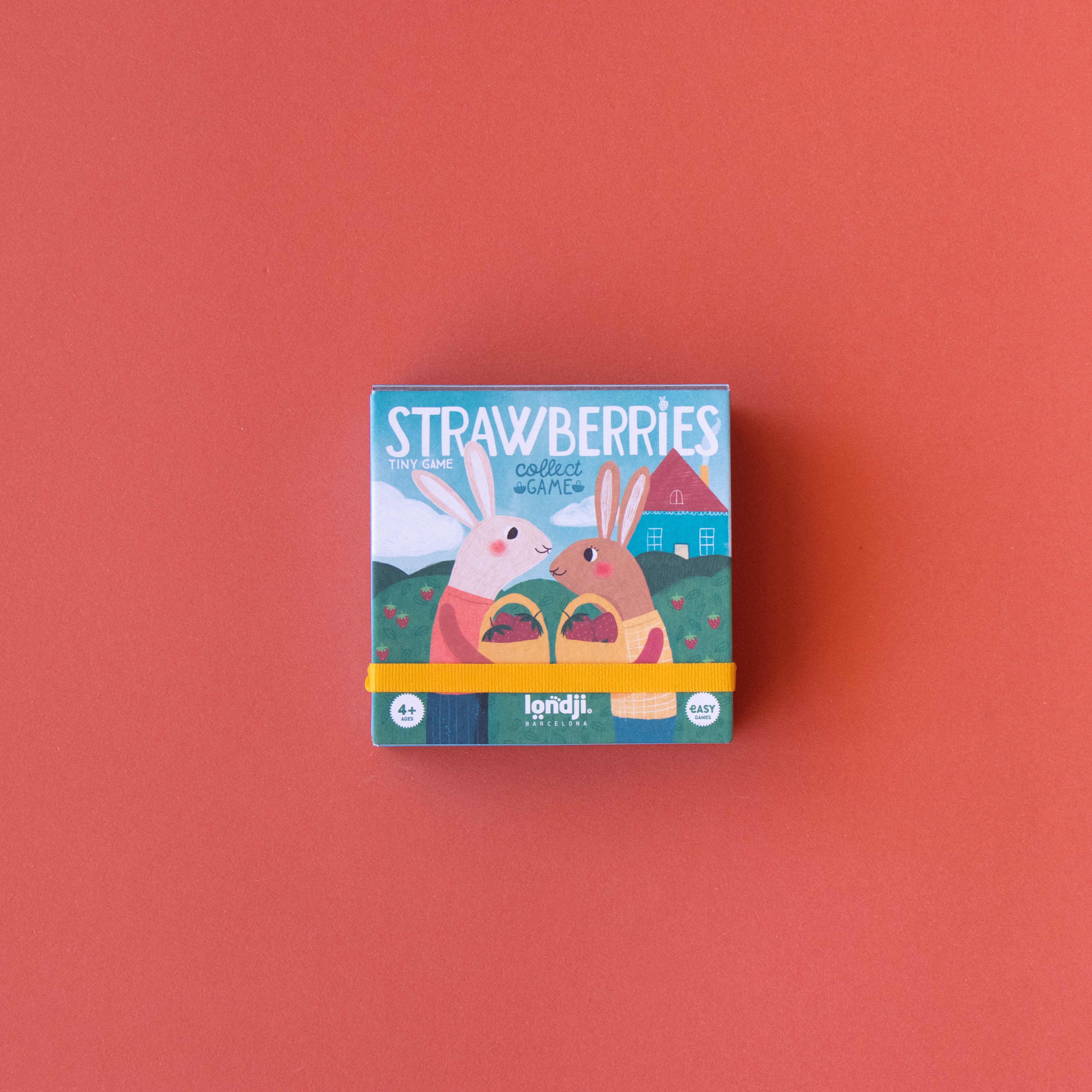 Mini jeu de collection & stratégie Strawberries de Londji avec illustration de lapins, fraises et blaireau dans un univers de forêt. — Londji Strawberries mini collection and strategy game with rabbits, strawberries and a badger in a forest-themed design.